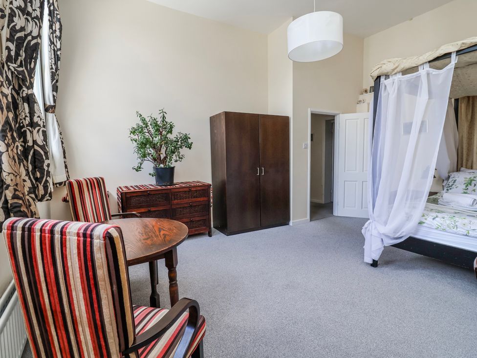 A bedroom with a bed, wardrobe and table at Top floor apartment