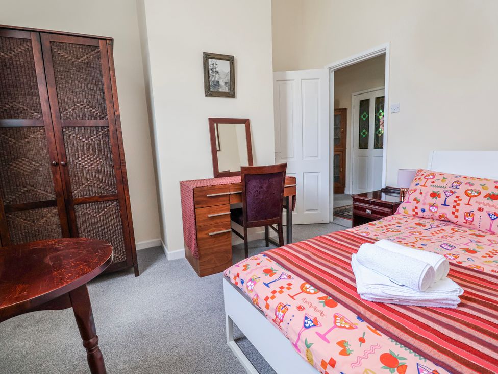 A bedroom with a bed and a vanity table at Top floor apartment 