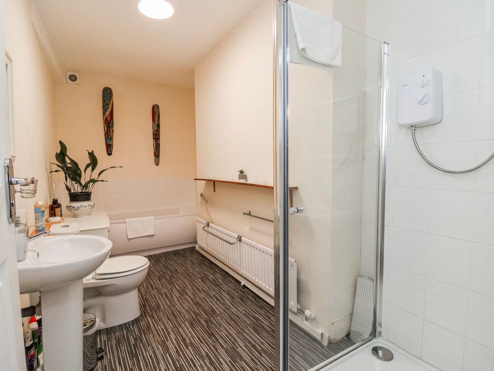 A bathroom with a bath tub, shower, toilet, and sink at Top floor apartment