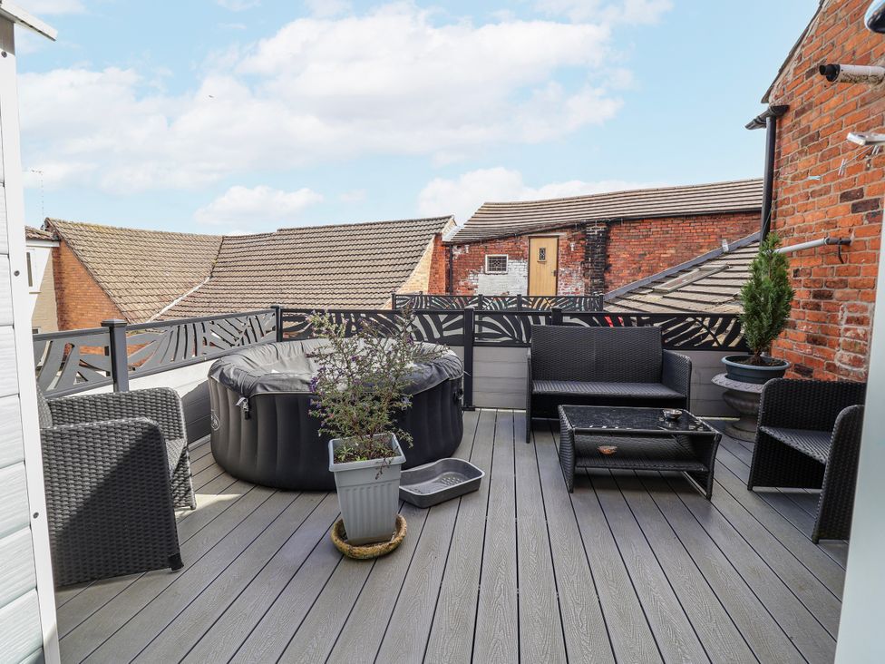 A roof terrace with a hot tub and seating at Top floor apartment