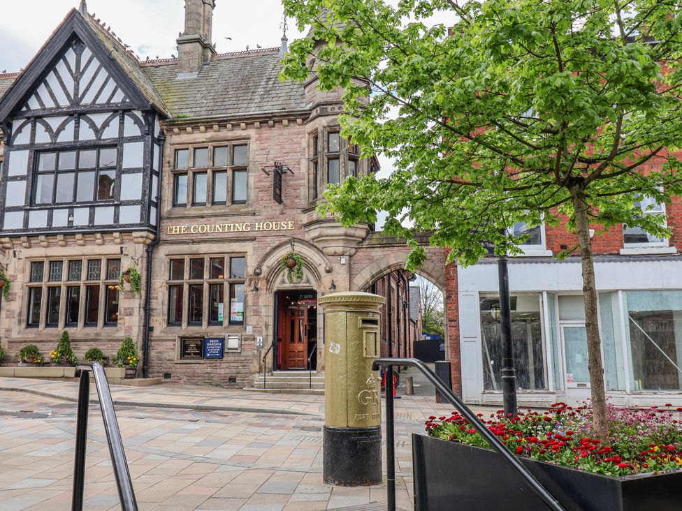 A building with a pub sign and post box at The Counting House