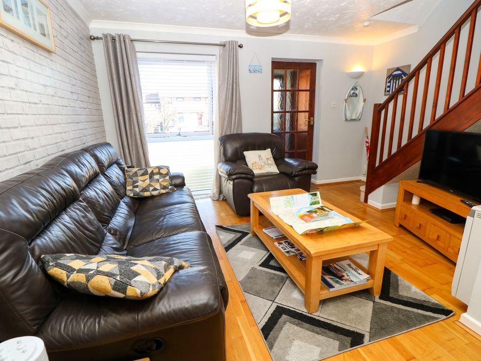 A living room with a sofa and coffee table at 73 Pennywell Gardens in New Milton