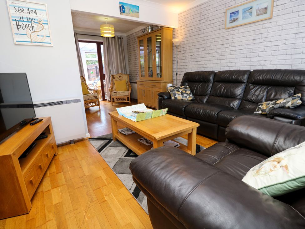 A living room with a sofa and coffee table at 73 Pennywell Gardens New Milton
