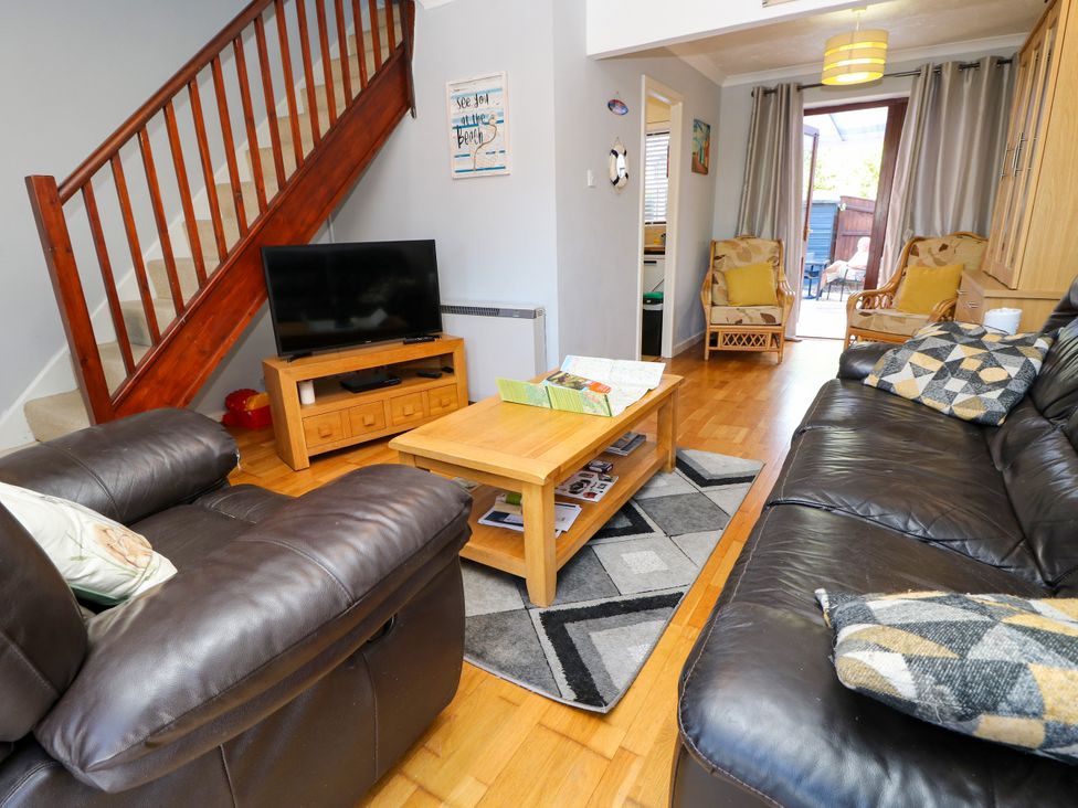 A living room with a television and coffee table at 73 Pennywell Gardens in New Milton