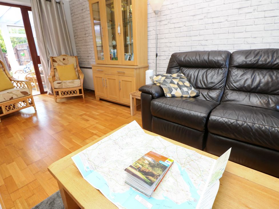 A living room with a sofa and chairs in 73 Pennywell Gardens New Milton