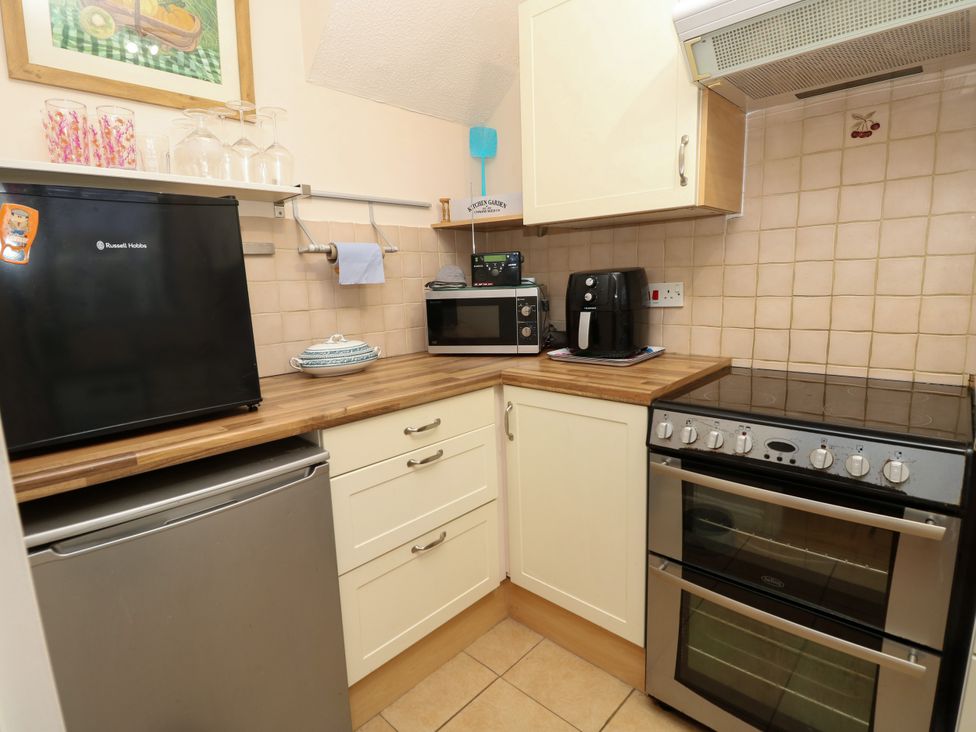 A kitchen with appliances and countertop at 73 Pennywell Gardens New Milton
