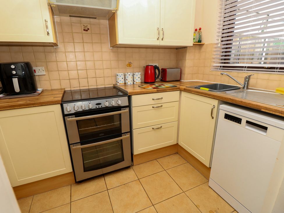 A kitchen with appliances including an oven and sink at 73 Pennywell Gardens New Milton