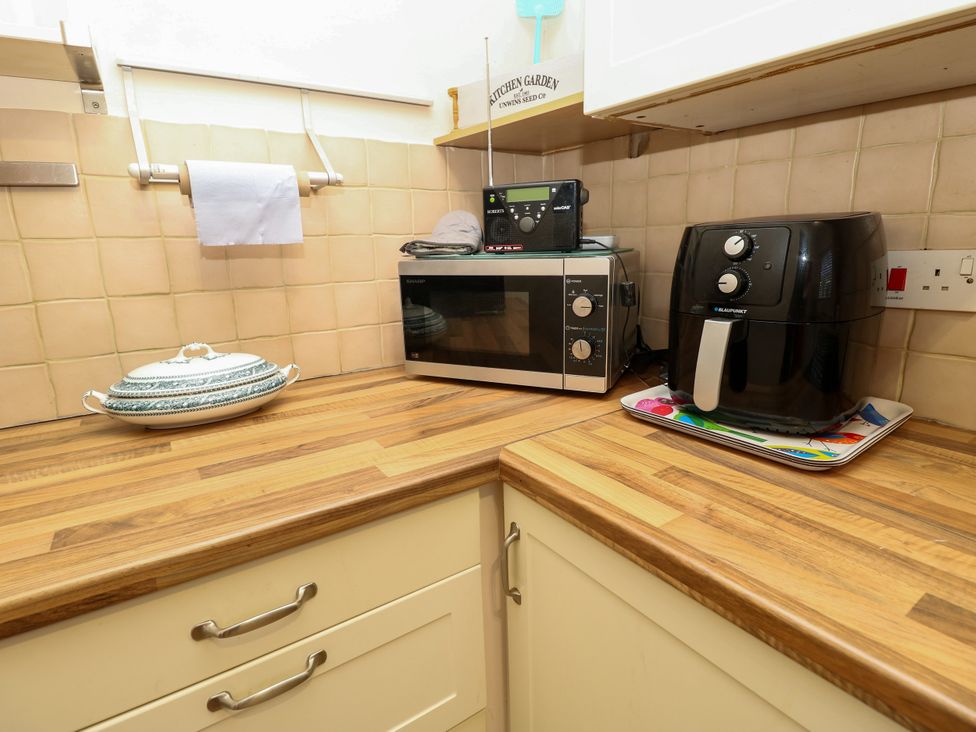 A kitchen with a microwave and air fryer at 73 Pennywell Gardens in New Milton