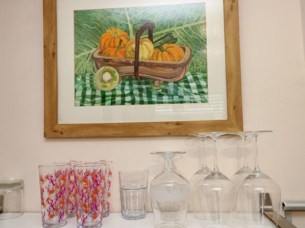 A collection of glasses and a framed painting in the kitchen at 73 Pennywell Gardens in New Milton