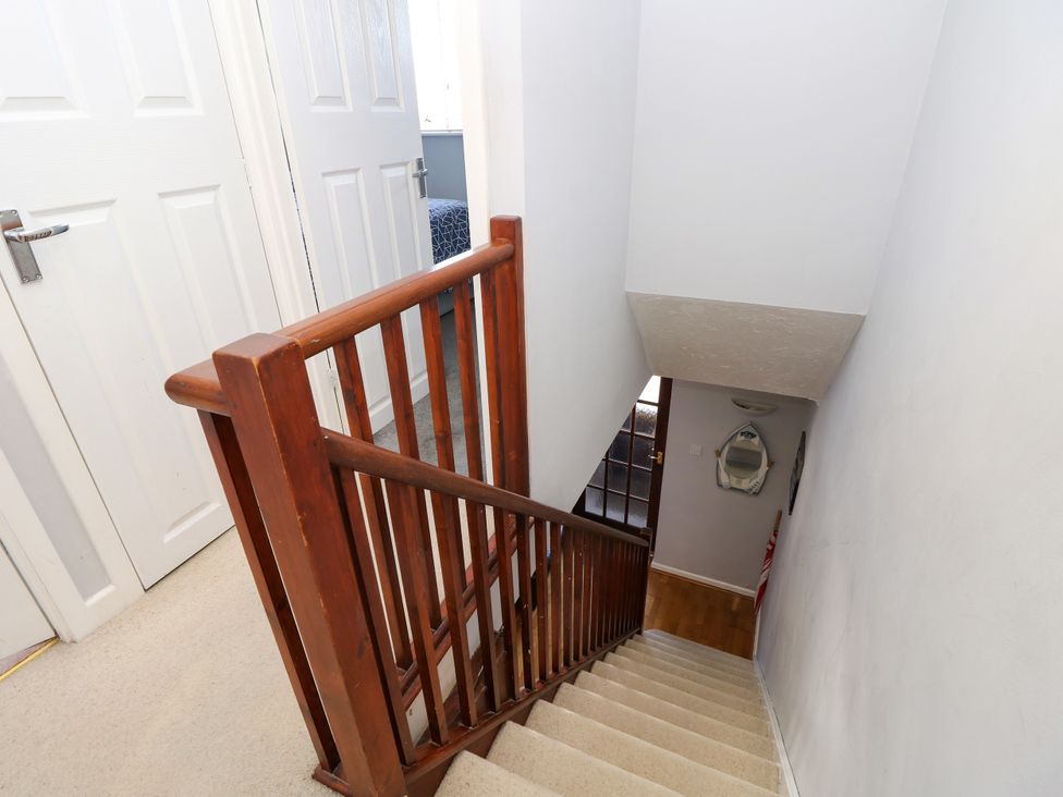 A staircase with a handrail and doors at 73 Pennywell Gardens in New Milton