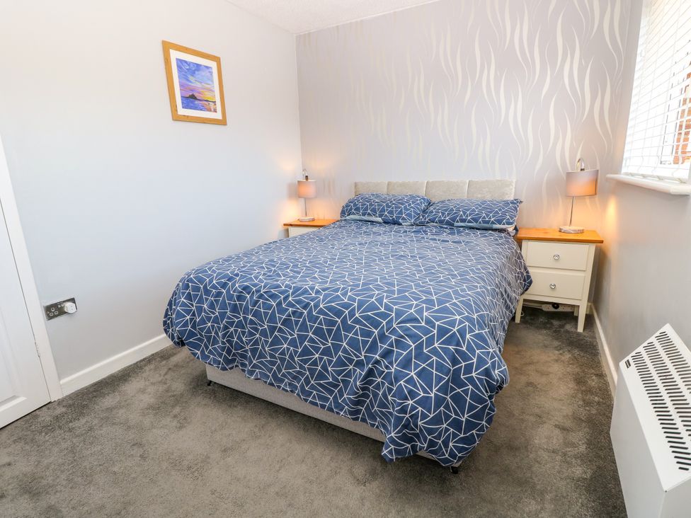 A bedroom featuring a bed and bedside tables at 73 Pennywell Gardens New Milton