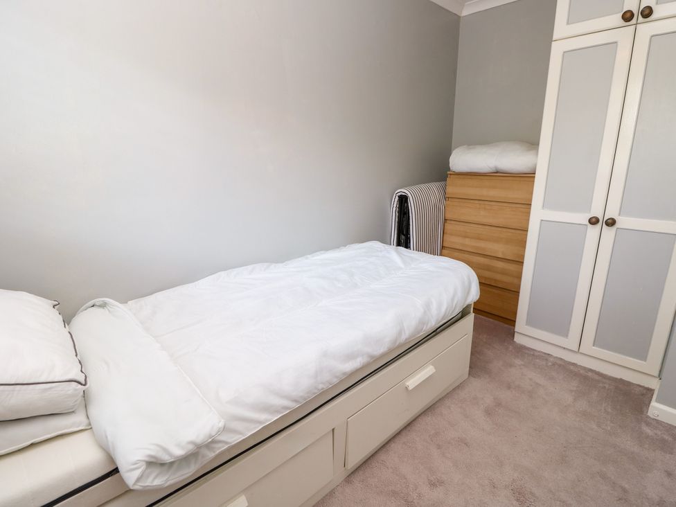 A bedroom with a single bed and storage unit at 73 Pennywell Gardens New Milton