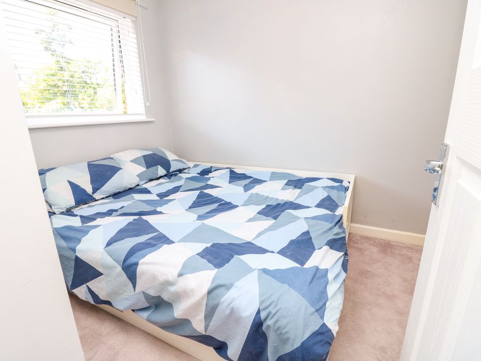 A bedroom with a bed and pillows at 73 Pennywell Gardens in New Milton
