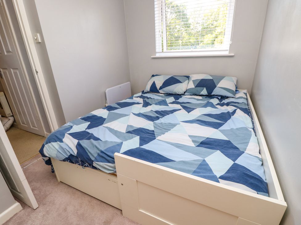 A bedroom with a bed and pillows at 73 Pennywell Gardens in New Milton