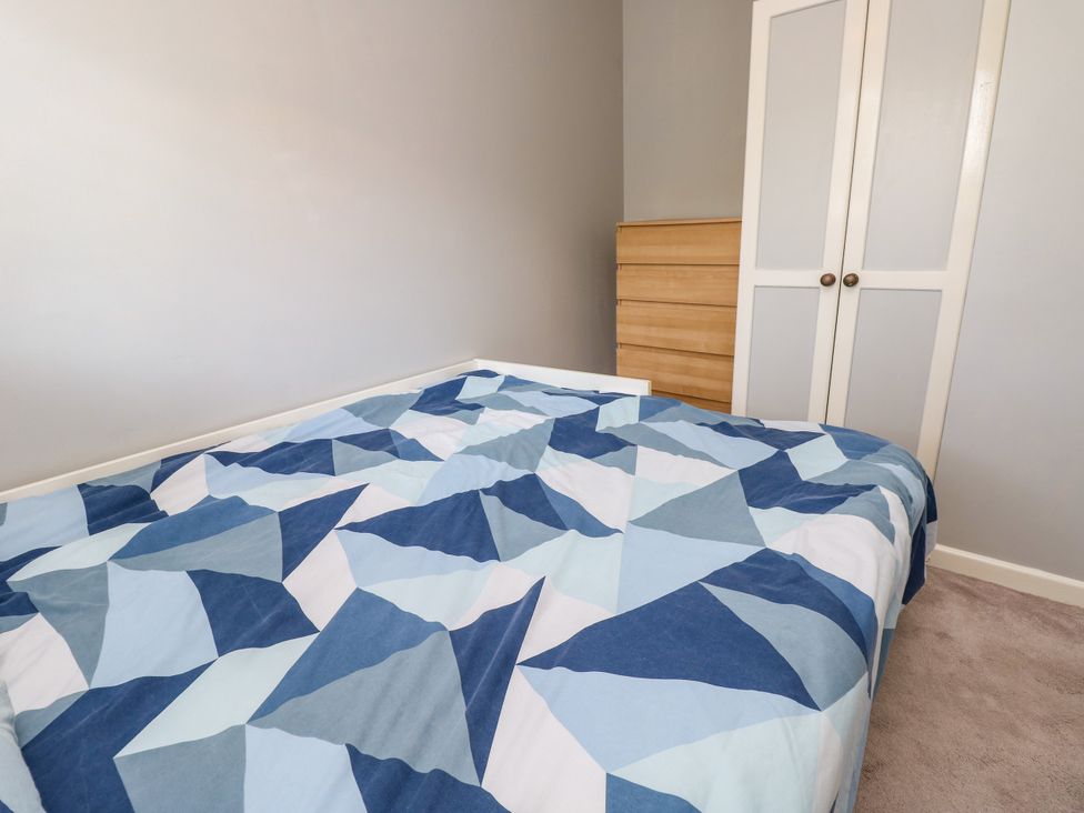 A bedroom with a bed and wardrobe at 73 Pennywell Gardens in New Milton