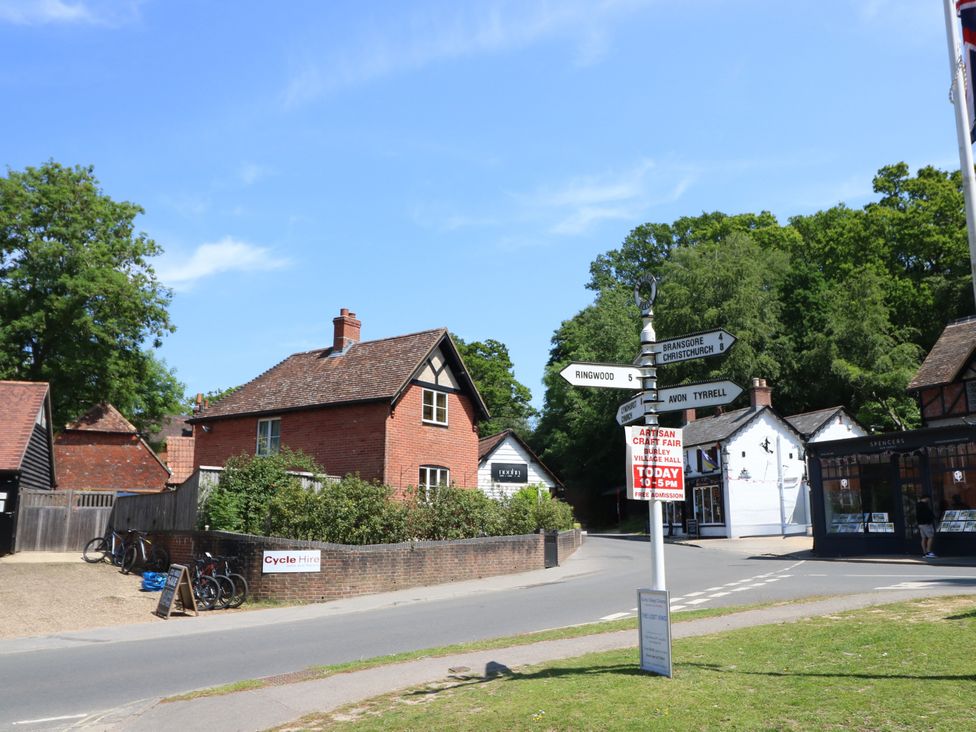 A street view with houses and a signpost at 73 Pennywell Gardens New Milton
