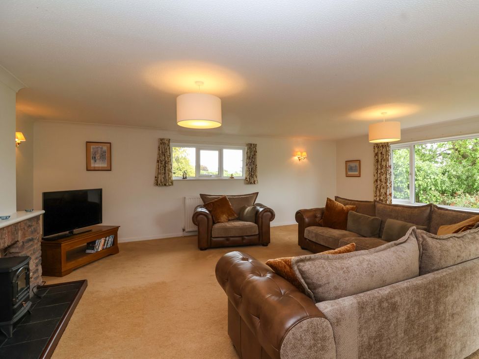 A living room with sofas and a television at 26 Five Bells in Watchet