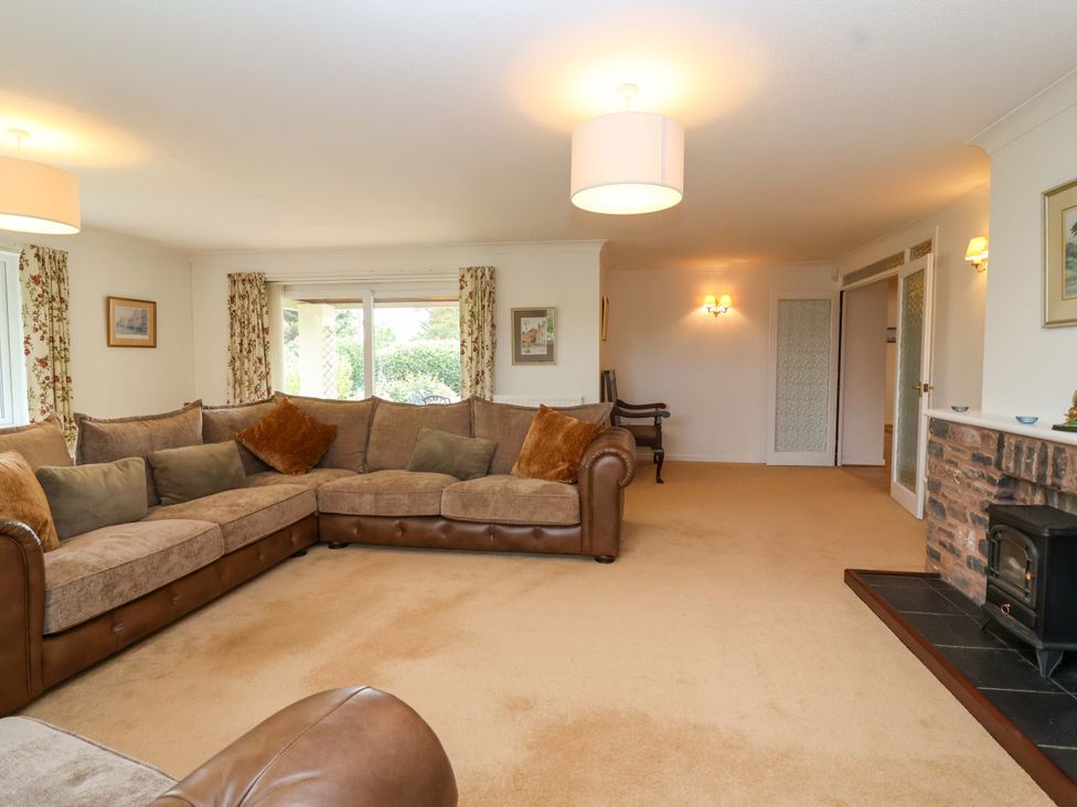 A living room with a sofa and fireplace at 26 Five Bells in Watchet