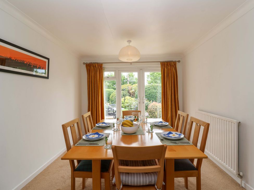 A dining room with a table set for dinner at 26 Five Bells in Watchet
