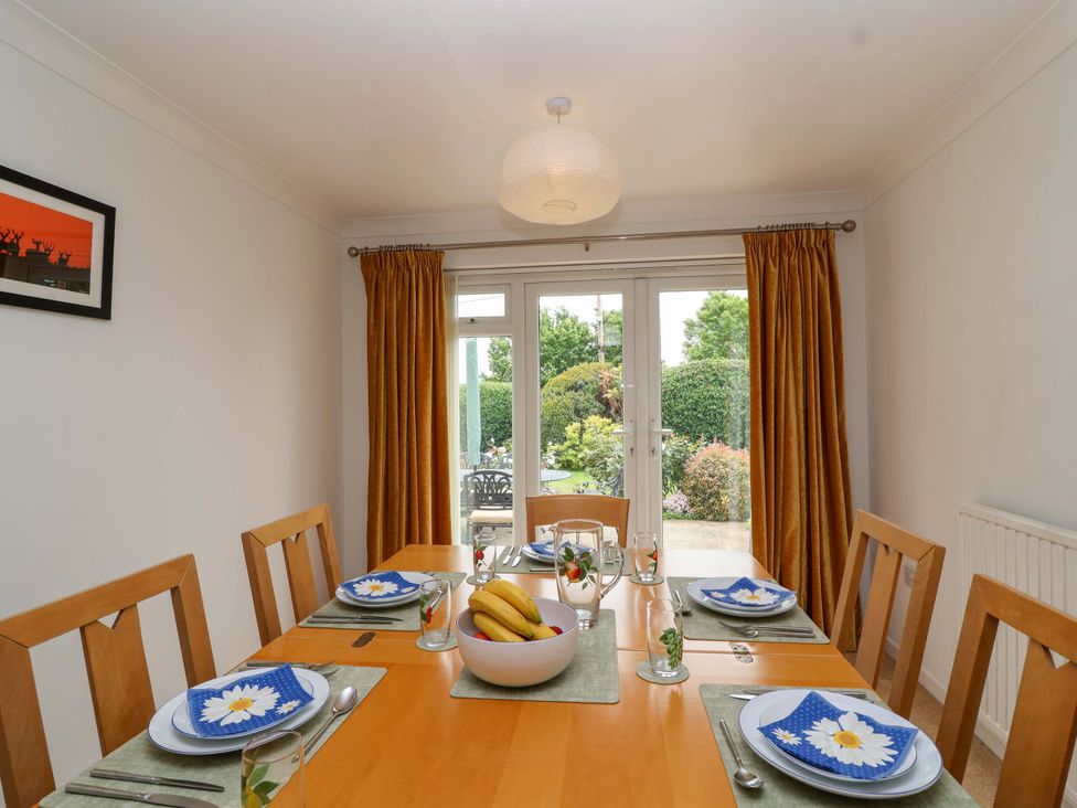 A dining room with a table set for a meal at 26 Five Bells Watchet