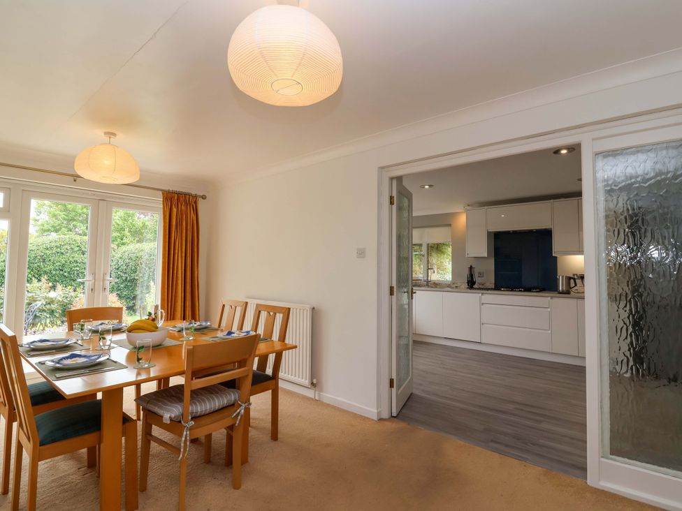 A dining room with a table set for dinner at 26 Five Bells in Watchet