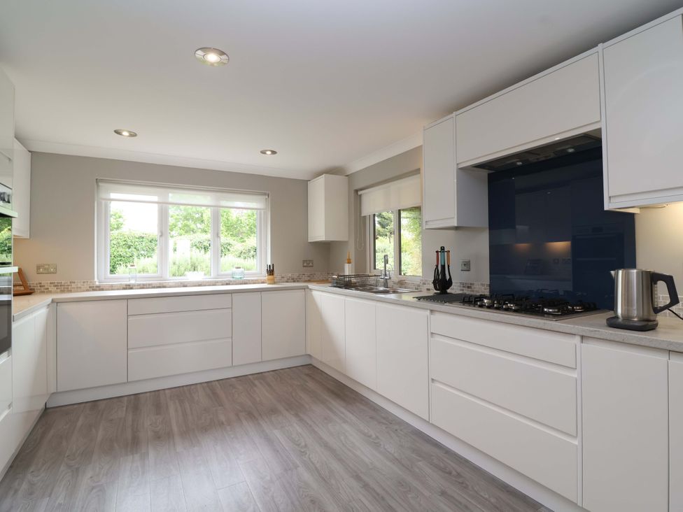A kitchen with modern appliances and window at 26 Five Bells Watchet