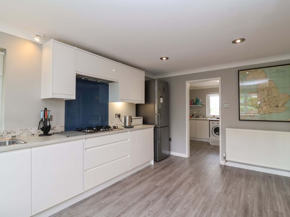 A kitchen with appliances and a map on the wall at 26 Five Bells in Watchet