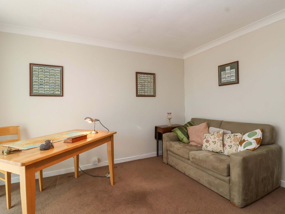 A living room with a sofa and table at 26 Five Bells in Watchet