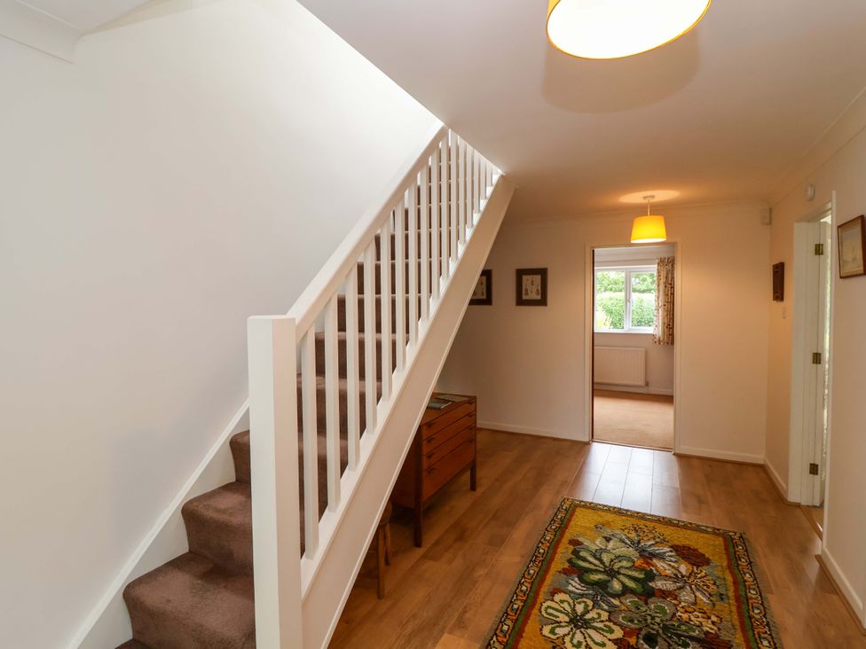 A hallway with stairs and a chest of drawers at 26 Five Bells in Watchet