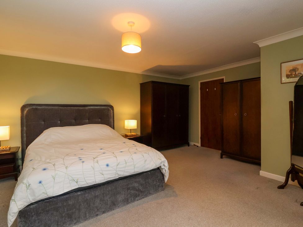 A bedroom with a bed and wardrobe at 26 Five Bells in Watchet