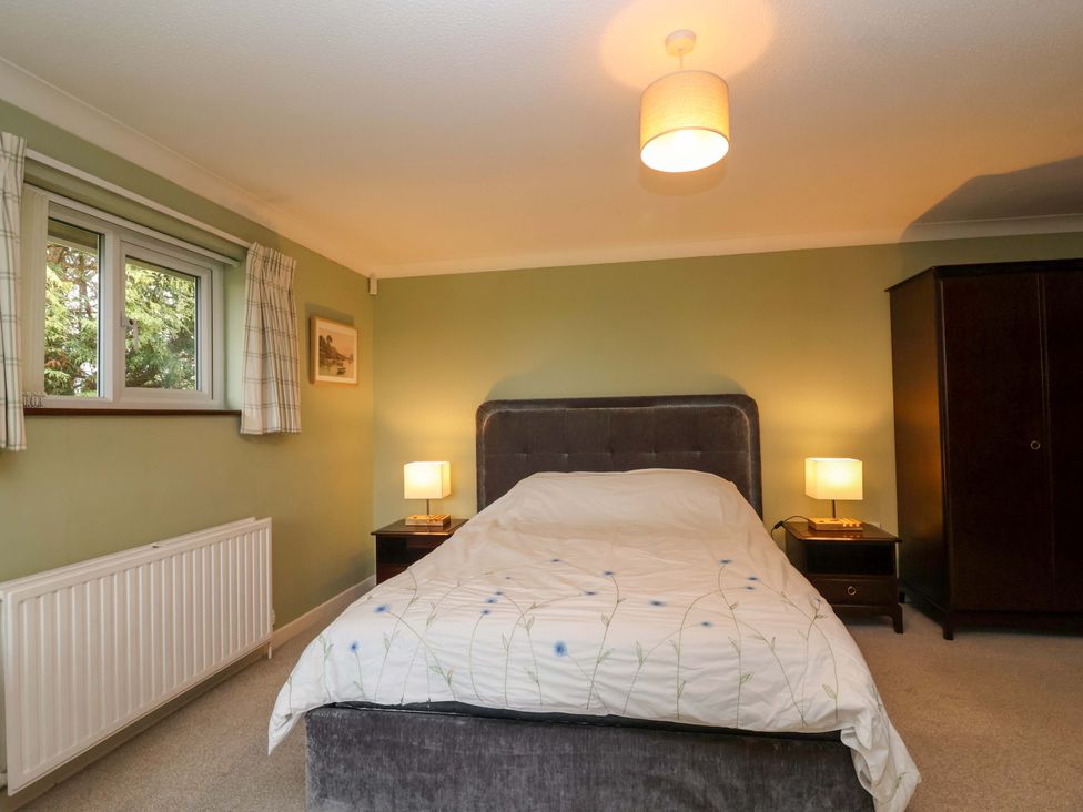 A bedroom with a bed and bedside lamps at 26 Five Bells in Watchet