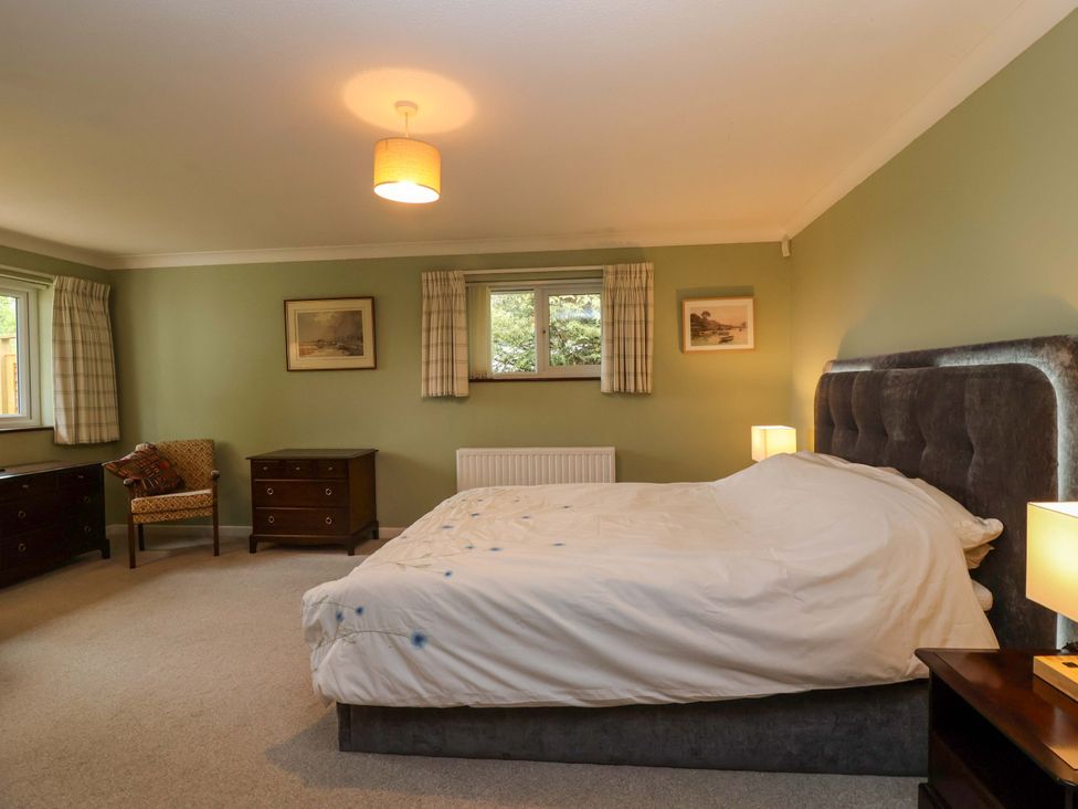A bedroom with a bed and nightstands at 26 Five Bells Watchet
