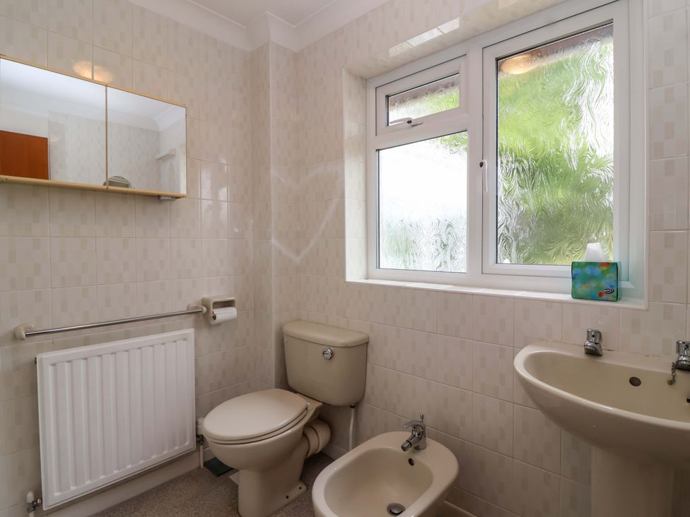 A bathroom with a toilet, sink, and bidet at 26 Five Bells in Watchet