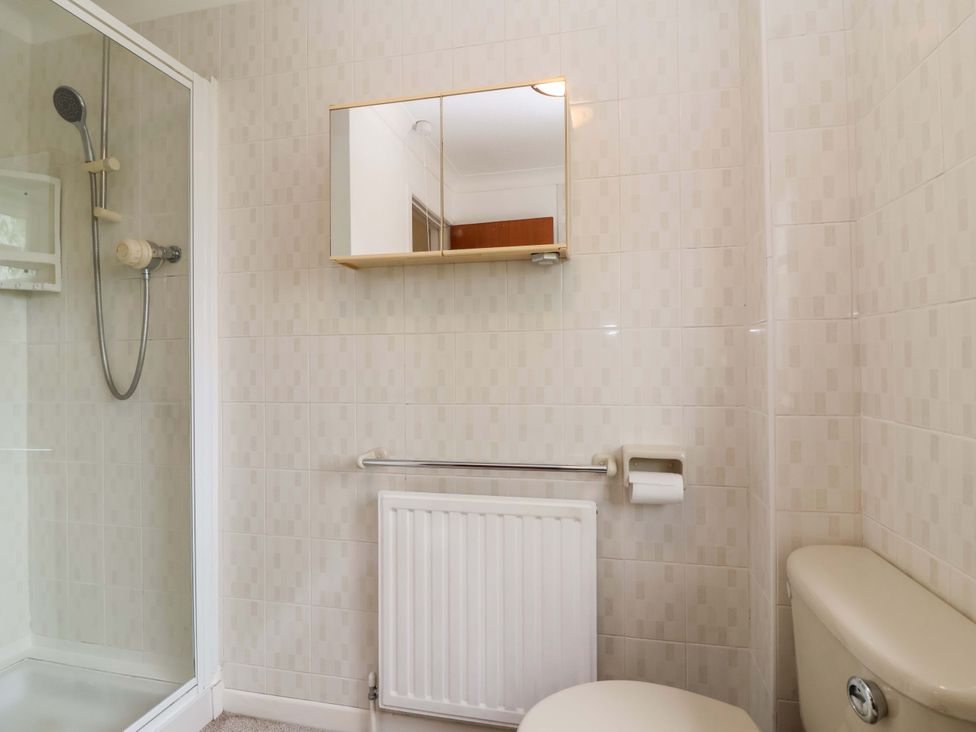 A bathroom with a shower and toilet at 26 Five Bells in Watchet