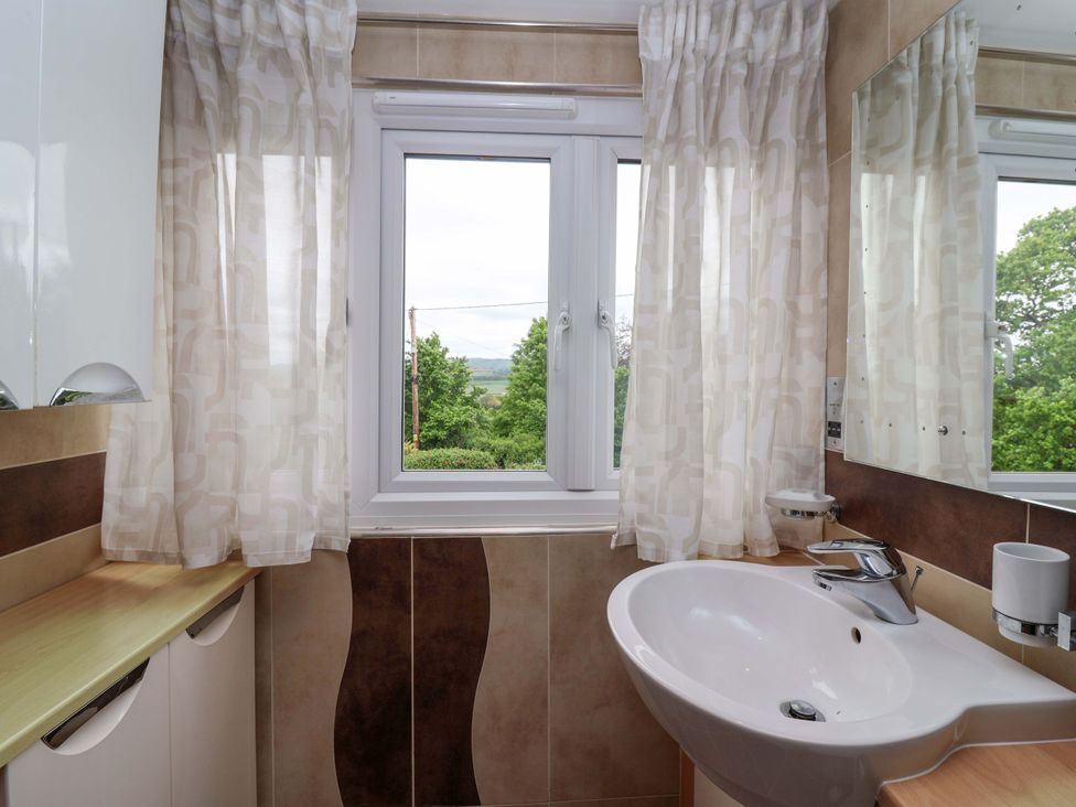 A bathroom with a sink and window at 26 Five Bells in Watchet
