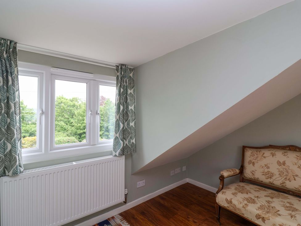 A sitting room with a sofa and windows at 26 Five Bells Watchet