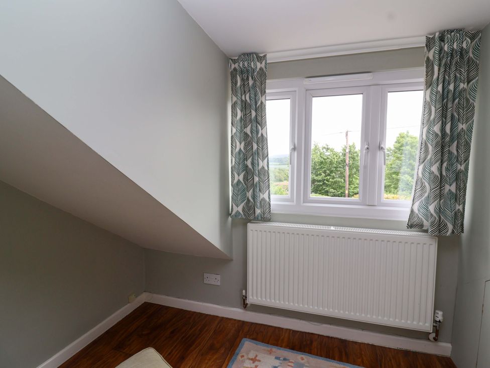 A room with a window and radiator at 26 Five Bells in Watchet