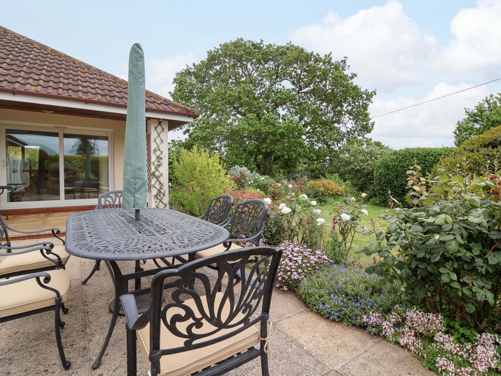 An outdoor dining area with chairs and table at 26 Five Bells in Watchet