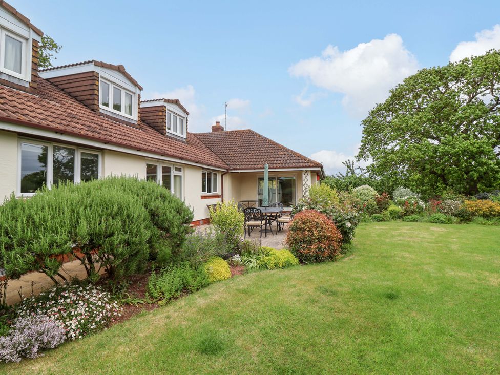 A garden with a patio and seating at 26 Five Bells in Watchet