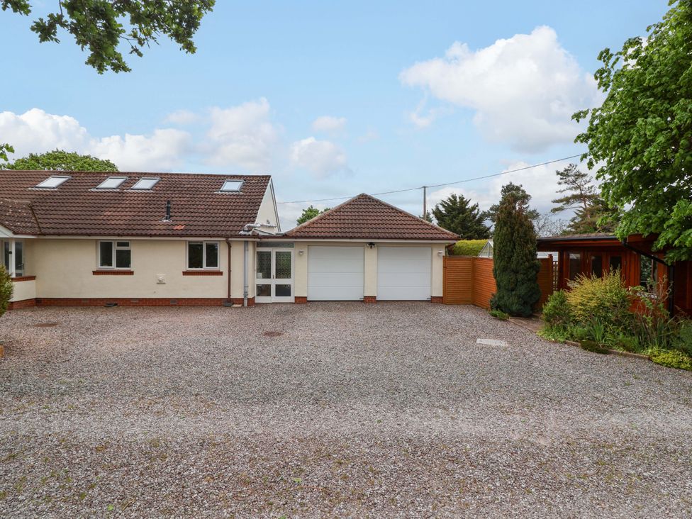 An exterior view of a house with a driveway and garage at 26 Five Bells in Watchet
