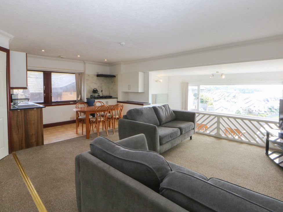 A living room with a sofa and dining area at Seaview in Y Felinheli