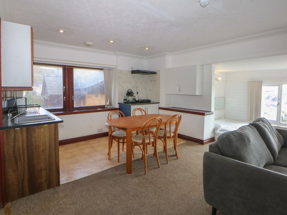 A living room with a kitchen area and dining table at Seaview in Y Felinheli