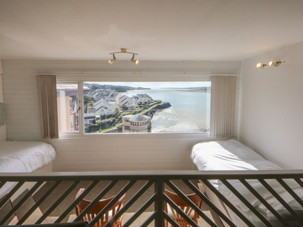 A bedroom with two beds and a view of the water at Seaview in Y Felinheli
