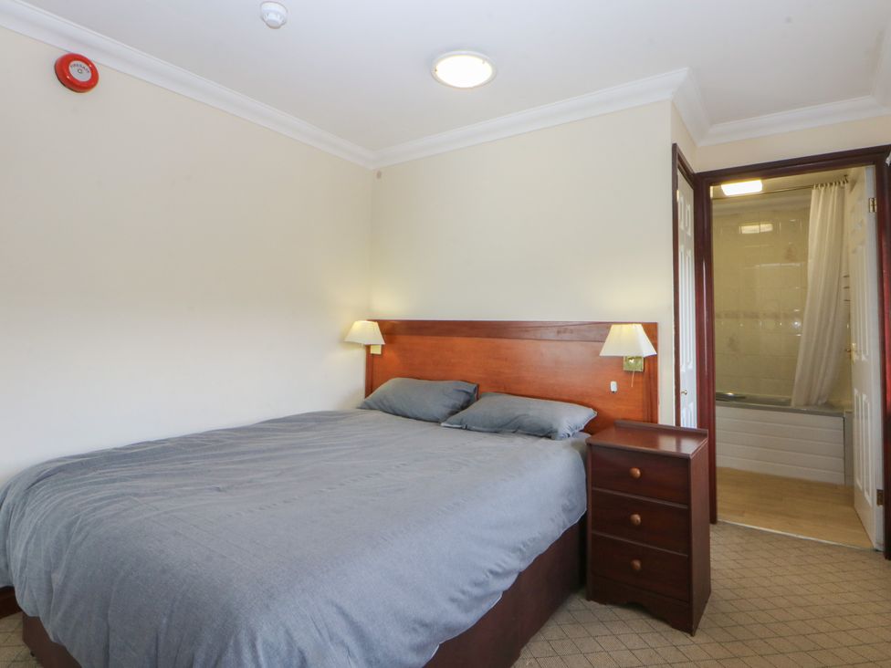 A bedroom with a bed and nightstand at Seaview in Y Felinheli