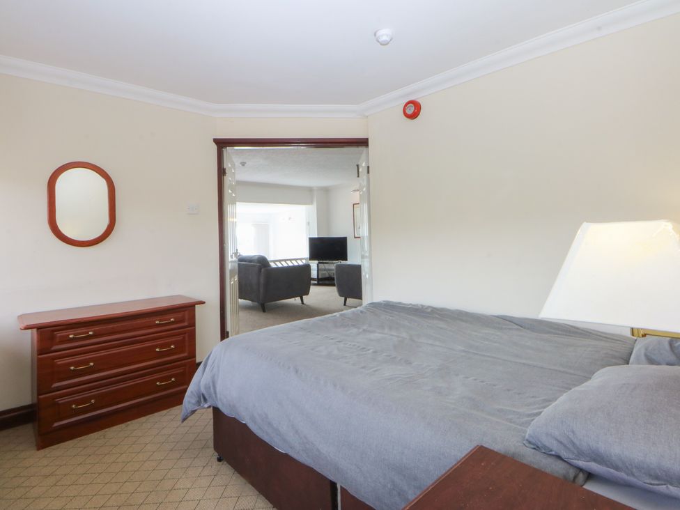 A bedroom with a bed and dresser at Seaview in Y Felinheli