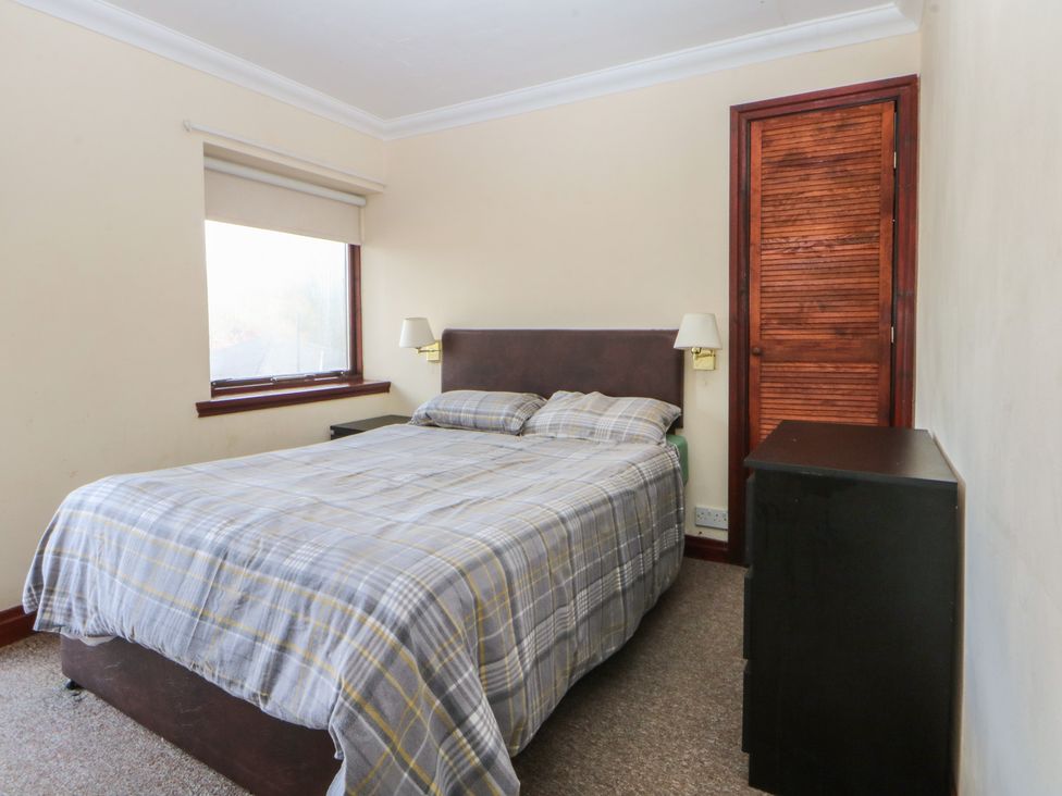 A bedroom with a bed and nightstand at Seaview Y Felinheli