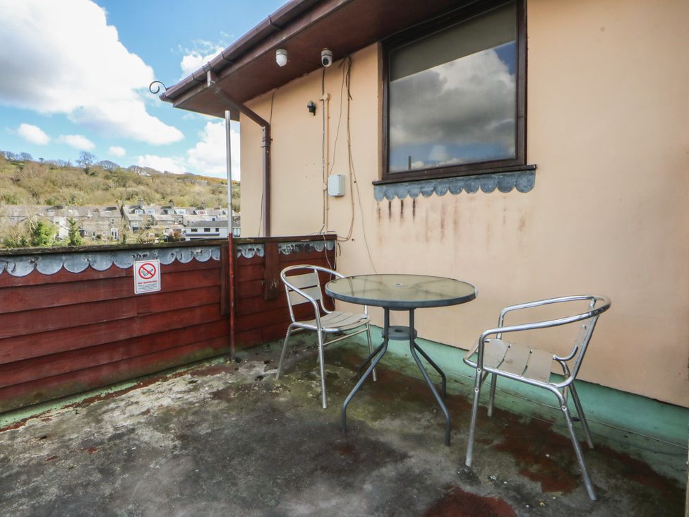 A balcony with a table and chairs at Seaview in Y Felinheli