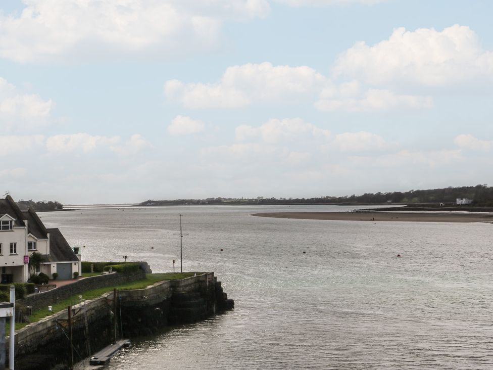 A view of a river with houses and shoreline at Seaview in Y Felinheli