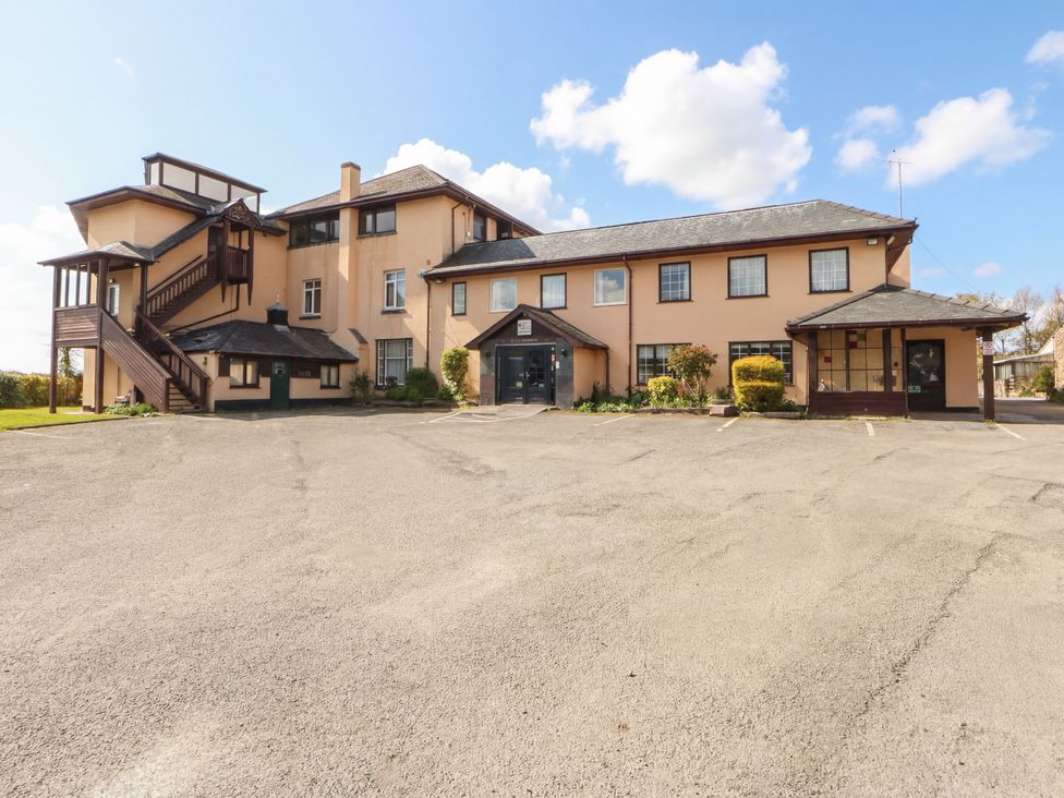 An exterior view of a building with stairs and parking area at Seaview in Y Felinheli