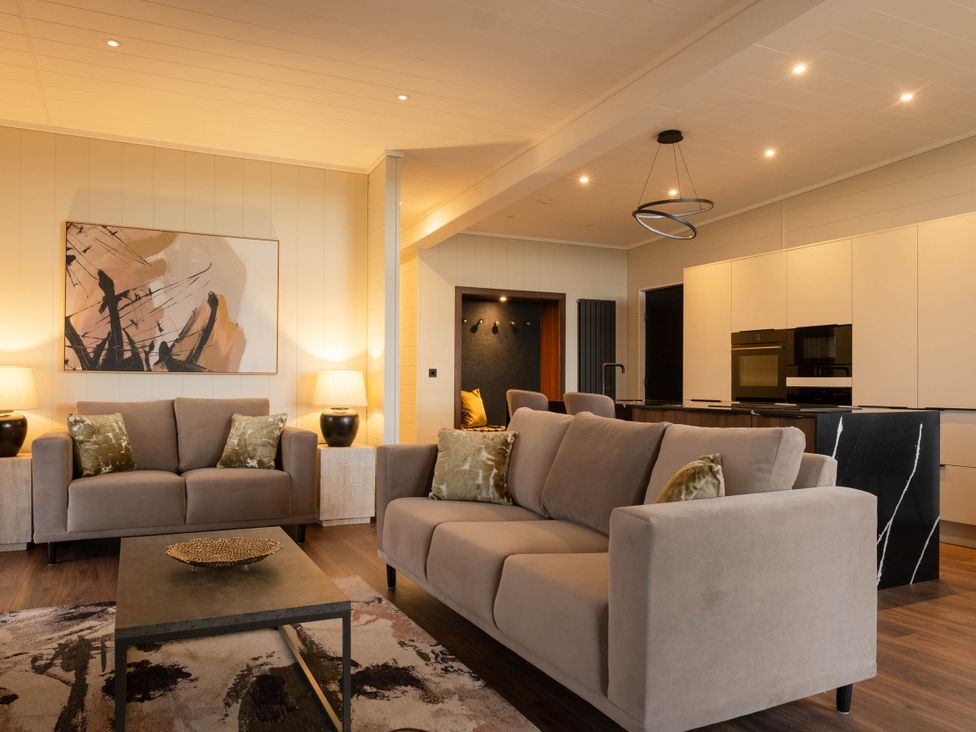 A living room with a sofa and coffee table at Exclusive Tempest Spa in Grimsby